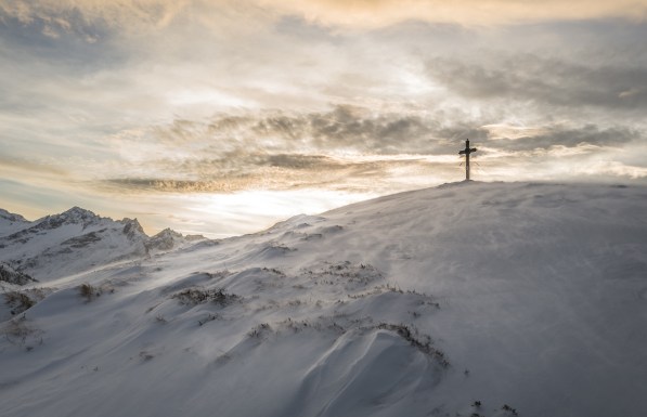 cross-on-snow-covered-mountain